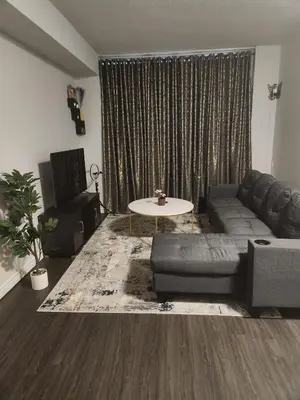 a living room with a couch and a table at Kanp version shared Apartments Toronto in Toronto