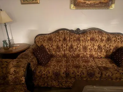 a couch sitting in a living room next to a table at Hespeler Haven Hideaway in Cambridge