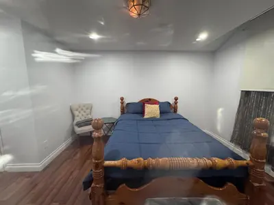 a bedroom with a bed with a blue comforter at 3409 McDowell Drive Mississauga Ontario L5M6R7 in Mississauga