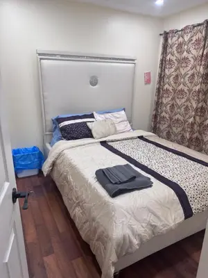 a small bedroom with a bed with a headboard at 3409 McDowell Drive Mississauga Ontario L5M6R7 in Mississauga