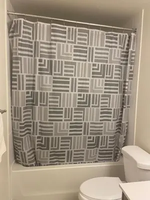 a shower curtain in a bathroom with a toilet at Modern Private Room with Ensuite in Vaughan