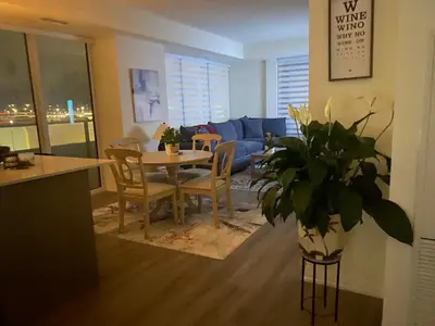 a living room with a table and a couch at Modern Private Room with Ensuite in Vaughan