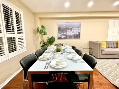 a dining room with a table and chairs at Maison Laurier, Modern 5B4B Home Inc BSMT Free parking, Close to trails in Richmond Hill