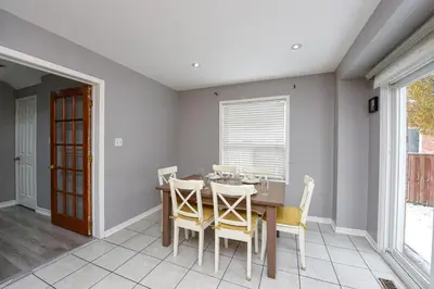 a dining room with a table and chairs at Entire 4BR 3BA Home in Mississauga, Sleeps 8, 10 mins to Pearson Airport in Mississauga