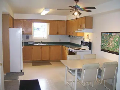 a kitchen with a table and a white refrigerator at Lakeshore North - Waterloo, Ontario in Waterloo