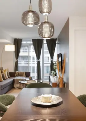a table with a cake on it in a living room at Upscale King Suite Near CN Tower with Free Parking in Toronto