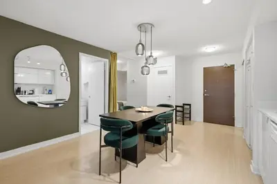 a dining room with a table and chairs and a mirror at Upscale King Suite Near CN Tower with Free Parking in Toronto
