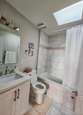 a bathroom with a toilet and a sink and a tub at Ensuite in New Home with Parking, Close to Bluffers Park, Lake Ontario, 15 Mins to Downtown in Toronto