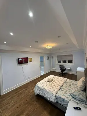 a bedroom with a bed and a desk in it at Ensuite in New Home with Parking, Close to Bluffers Park, Lake Ontario, 15 Mins to Downtown in Toronto