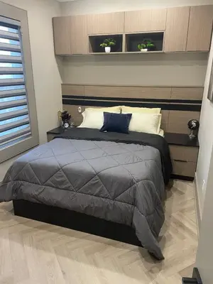 a bedroom with a bed and two plants on the wall at Modern 7 Bedroom Masterpiece on Portage Sleeps 16 in Niagara Falls