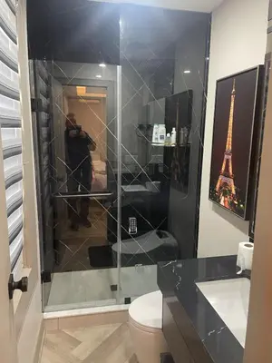 a man taking a picture of a bathroom with the eiffel tower at Modern 7 Bedroom Masterpiece on Portage Sleeps 16 in Niagara Falls