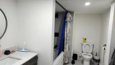 a bathroom with a toilet and a sink at Forest city family style furnished rooms in London