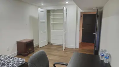a bedroom with a table and a room with a closet at Forest city family style furnished rooms in London