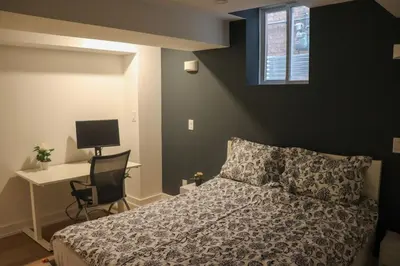 a bedroom with a bed and a desk with a computer at Luxury Brand-New Spacious Apartment in Richmond Hill in Richmond Hill