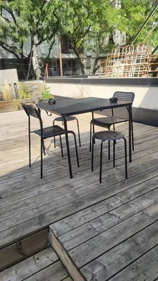 a black table and two chairs on a wooden deck at Toronto Downtown Holiday Home-Private Patio,Free Wifi & Self Checkin in Toronto