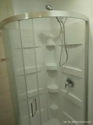 a shower with a glass door in a bathroom at Midtown Toronto studio in Toronto