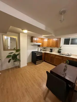 a large kitchen with a table and a dining room at 1 Bedroom Apartment Owen Sound in Owen Sound