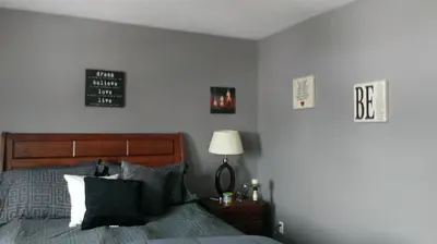 a bedroom with a bed and a sign on the wall at HB Guest Home 3 in Waterloo