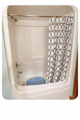 a bathroom with a toilet with a shower at Peaceful Forest Retreat with Fire Pit and BBQ near Mansfield Ski Club in Mulmur