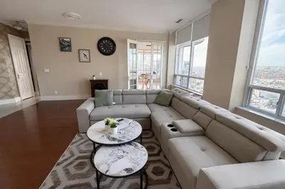a living room with a couch and a table at Luxury Penthouse with Celebration Square Views in Mississauga