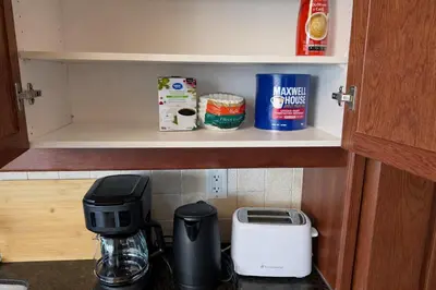 a cupboard with a coffee maker and other kitchen items at Luxury Penthouse with Celebration Square Views in Mississauga