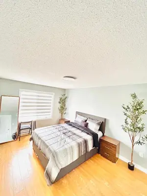 a bedroom with a bed and a tree in it at Luxury home Netflix & parking promo price with 7beds in Brampton