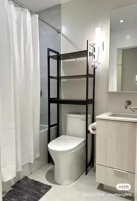 a white bathroom with a toilet and a sink at Cozy studio near Yonge Eglinton Subway Midtown in Toronto