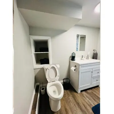 a bathroom with a toilet and a sink at Cozy Place in Oshawa