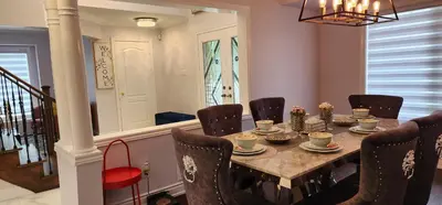 a dining room with a table with chairs and a dining room at Charming Room in Brampton