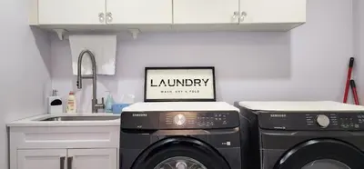 a kitchen with two washing machines and a sink at Charming Room in Brampton