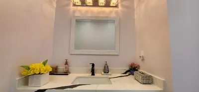 a bathroom with a sink and a mirror at Lavish Bright Bedroom in Brampton