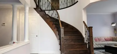 a winding staircase in a home with white walls at Lavish Bright Bedroom in Brampton
