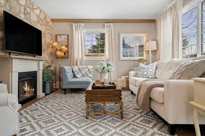 a living room with a couch and a fireplace at Modern French Cottage in Old Town The 506 in Niagara on the Lake