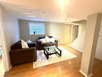 a living room with a couch and a table at Beautiful walkout basement in Georgetown