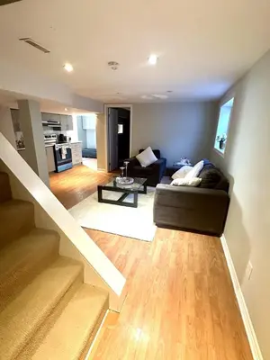 a living room with a couch and a table at Beautiful walkout basement in Georgetown