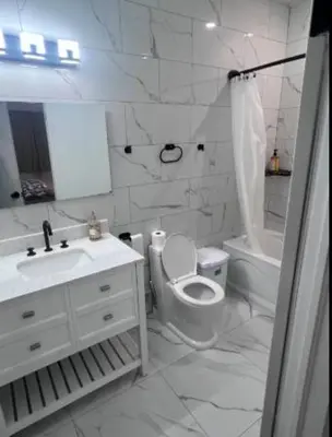 a white bathroom with a toilet and a sink at Pleasant Private Room In Cambridge 02 in Cambridge