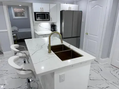 a kitchen with a sink and a refrigerator at Spacious 2 Bedroom, 1 Bathroom Luxury Apartment in Brampton