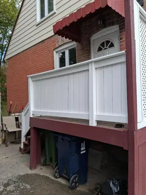 a house with a white deck on top of it at Greenhills - 3 bedroom suit - main floor in Toronto