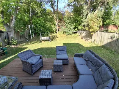 a patio with two couches and two chairs and a table at Greenhills - 3 bedroom suit - main floor in Toronto