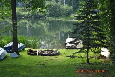a group of animals laying on the grass near a lake at Waterfront Muskoka Cottage on Trent-Severn River in Severn