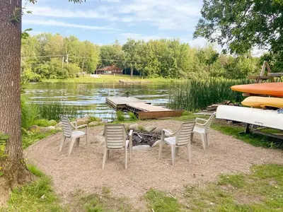 a group of chairs sitting in front of a lake at Waterfront Muskoka Cottage on Trent-Severn River in Severn