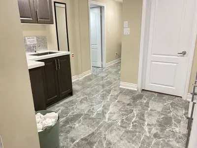 an empty kitchen with a sink and a door at Relaxing 2 Bedroom Basement Stay in Mississauga