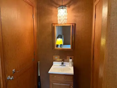 a bathroom with a sink and a mirror at Private Lakehouse Getaway Hot Tub on the Water in Waubaushene