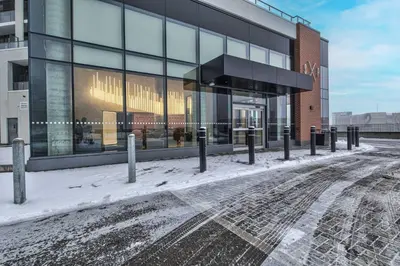 a building with a lot of snow in front of it at Stylish Downtown Suite with Patio & City Views in Kitchener