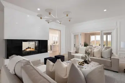 a living room with a couch and a fireplace at Vineyard Estate by the River with Pool in Niagara on the Lake