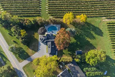 an aerial view of a house in a field at Vineyard Estate by the River with Pool in Niagara on the Lake