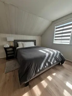a bedroom with a bed in a room with a window at Cozy 3BR House Near Airport & Transit! in Mississauga