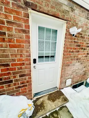 a white door on a brick wall at Sky Cove - Modern Comfort, Simple, Cozy, Central in Saint Thomas