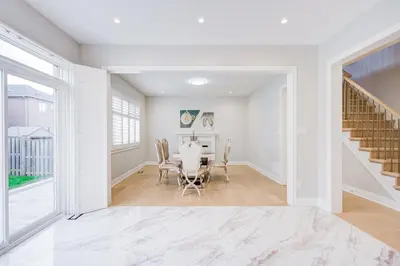 a white dining room with a table and chairs at Vantage stay Stouffville 4BR Bright Home in Stouffville