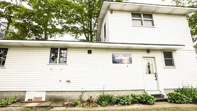 a white house with a white door at Cottage on Crystal Beach 3BR & BBQ in Fort Erie